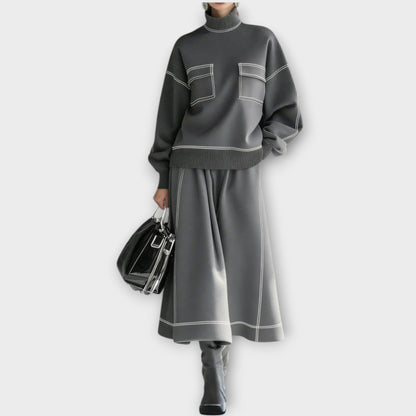 Femme portant ensemble 2 pièces gris charbon avec jupe midi